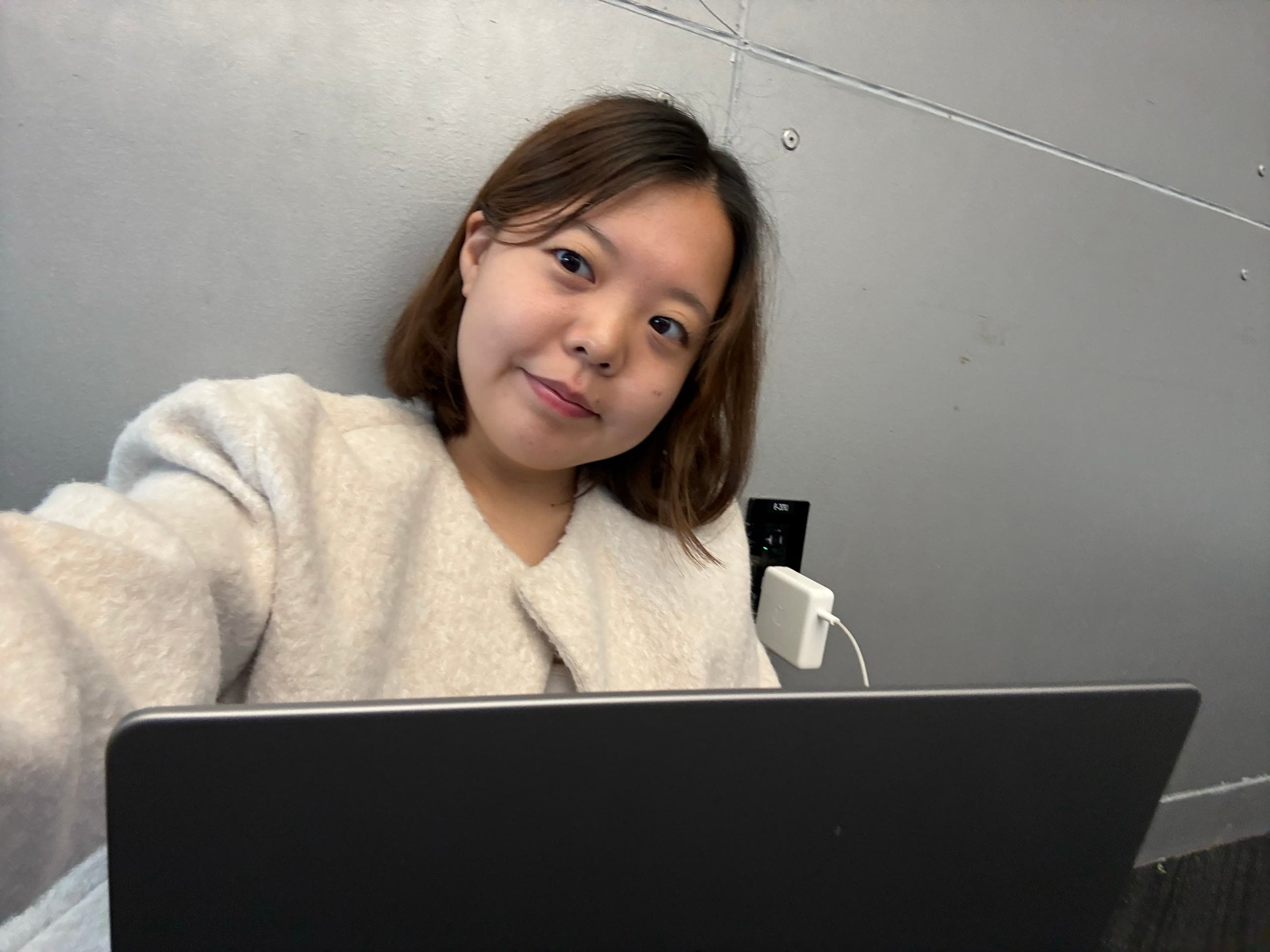 Jihyeon working on her laptop at a hackathon